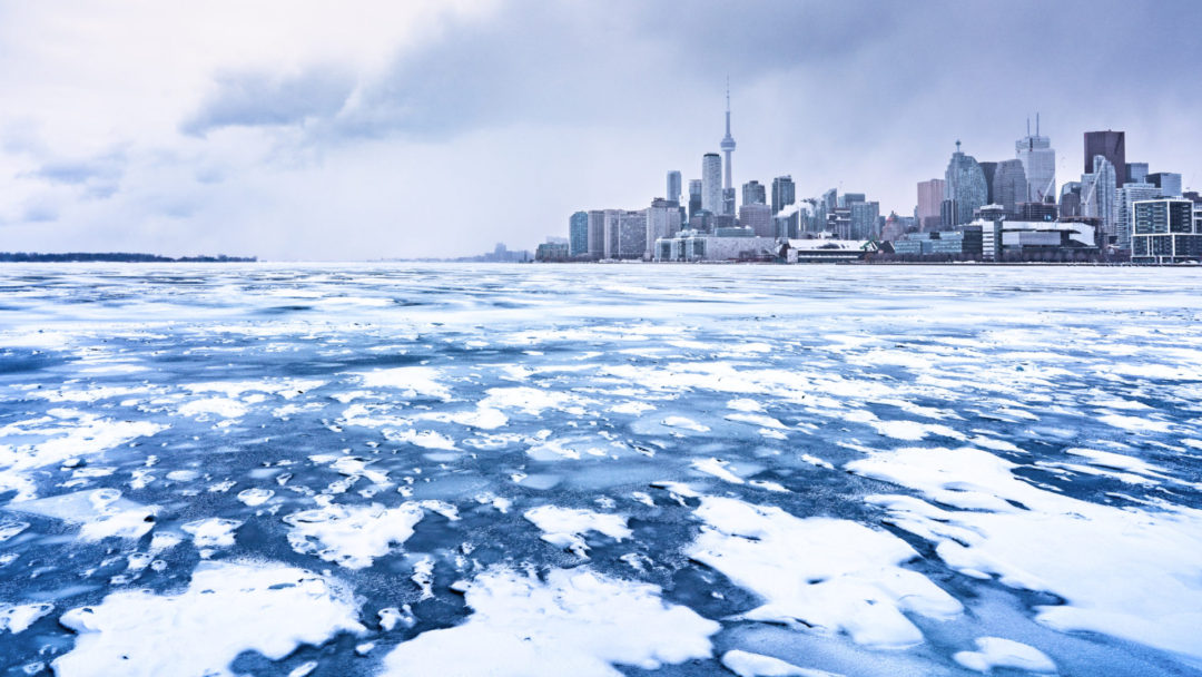 An icy lake in front of the city of Toronto, Canada