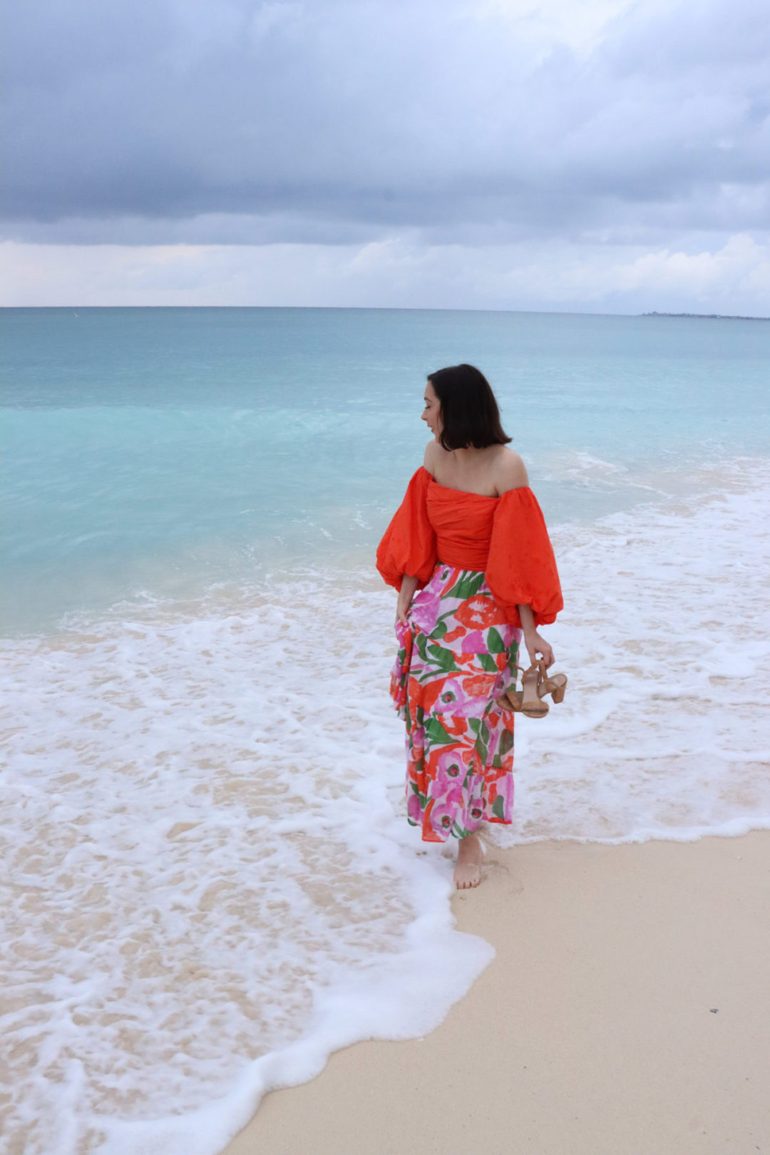 Travel Blogger Jordan Gassner looking out at the ocean while on Seven Mile Beach on Grand Cayman Island in the Caribbean