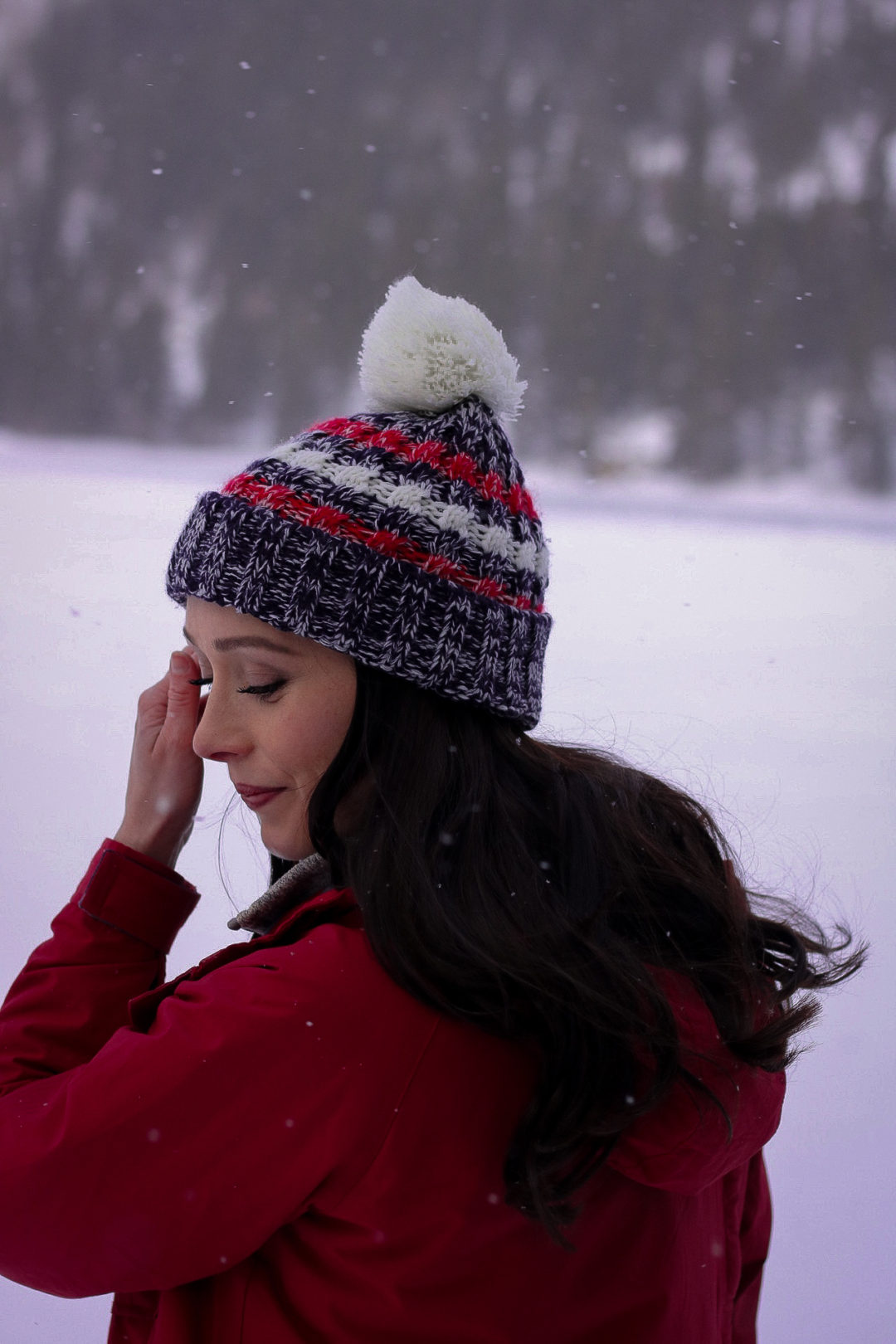 Travel Blogger Jordan Gassner pushing her hair out of her face and smiling in Rocky Mountain State Park in Colorado