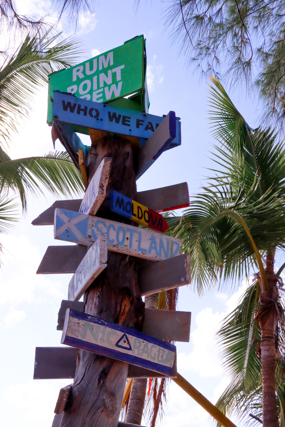 The infamous Rum Point directional pole, with signs like "Scotland" and "Moldova" in view.