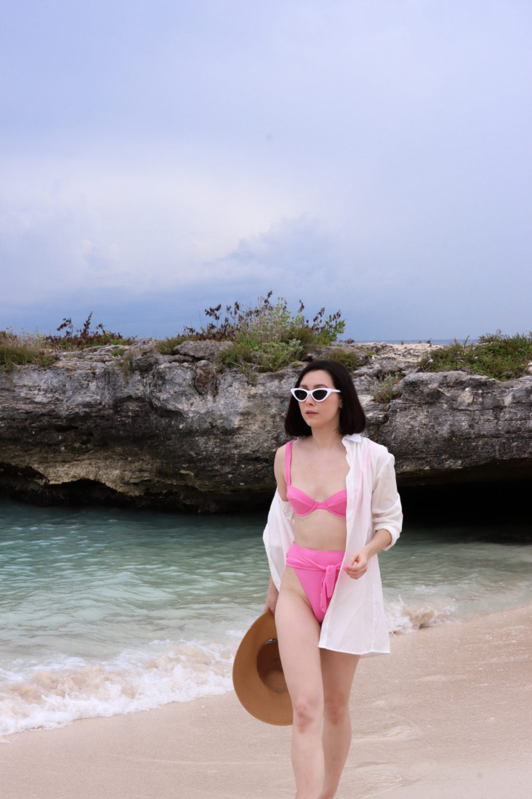 Travel Blogger Jordan Gassner walking along the shore at Smith Barcadere Beach on Grand Cayman in the Cayman Islands
