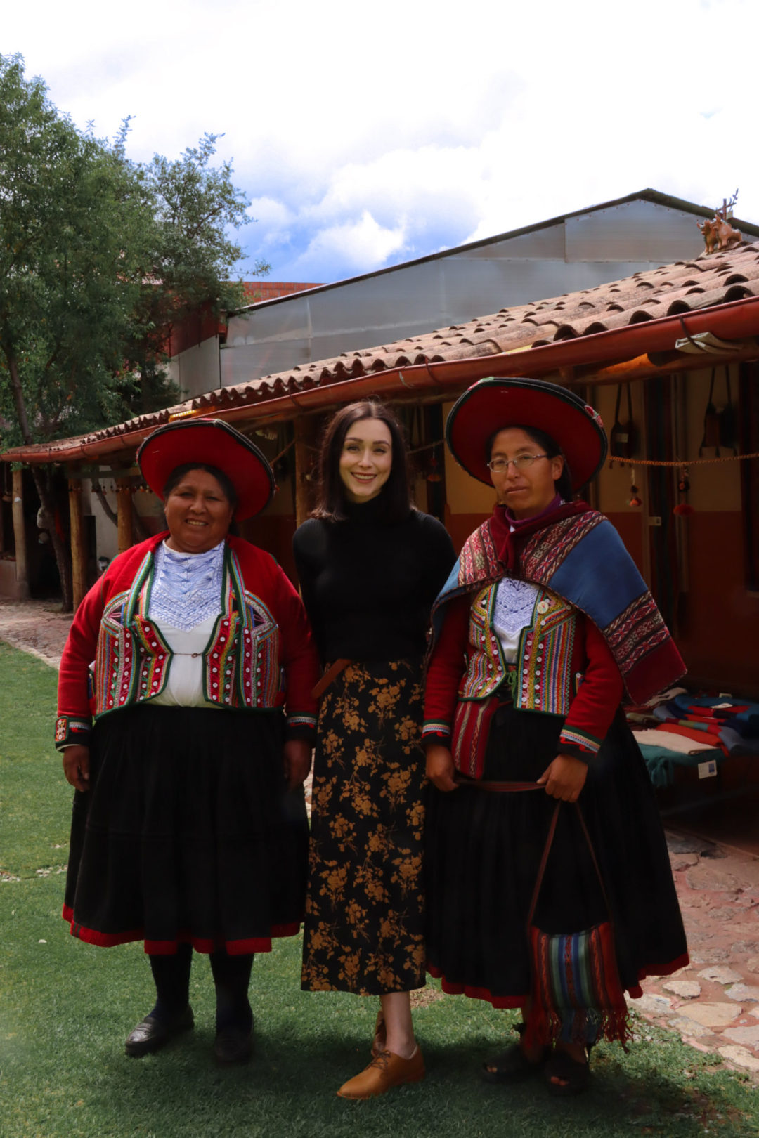 Travel Blogger Jordan Gassner and two Peruvian Women smiling at El Centro De Textiles Tradicionales De Cusco