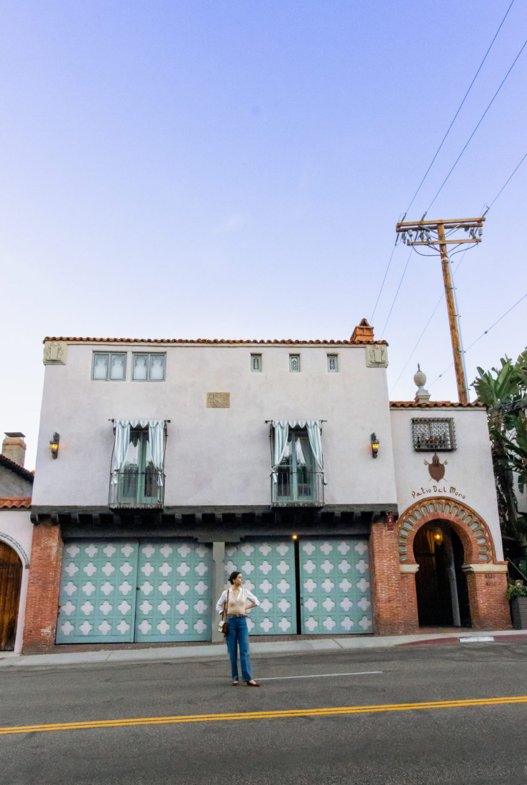 Travel Blogger Jordan Gassner standing with her hands on her hips in front of Patio El Moro in West Hollywood, California