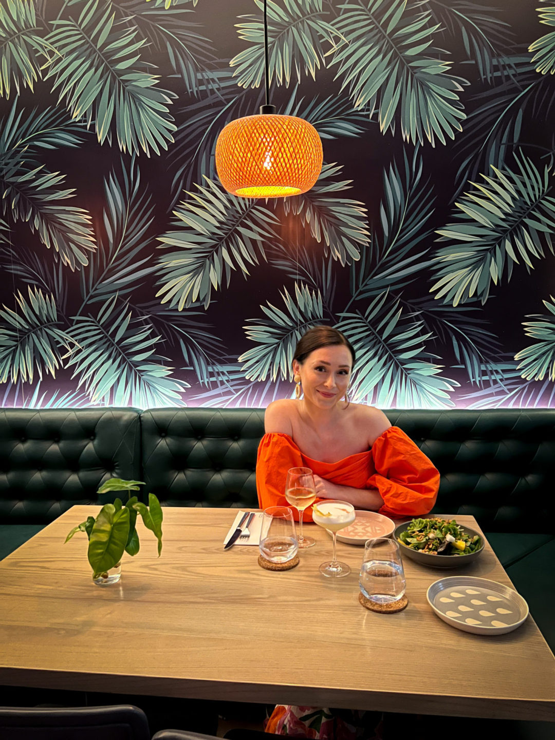 Travel Blogger Jordan Gassner smiling at camera a table inside Bayside Restaurant in Cayman Islands