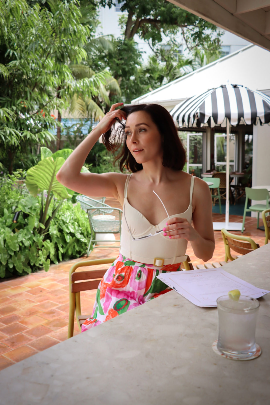 Travel Blogger Jordan Gassner fixing her hair at Ms. Piper's Restaurant in Cayman Islands