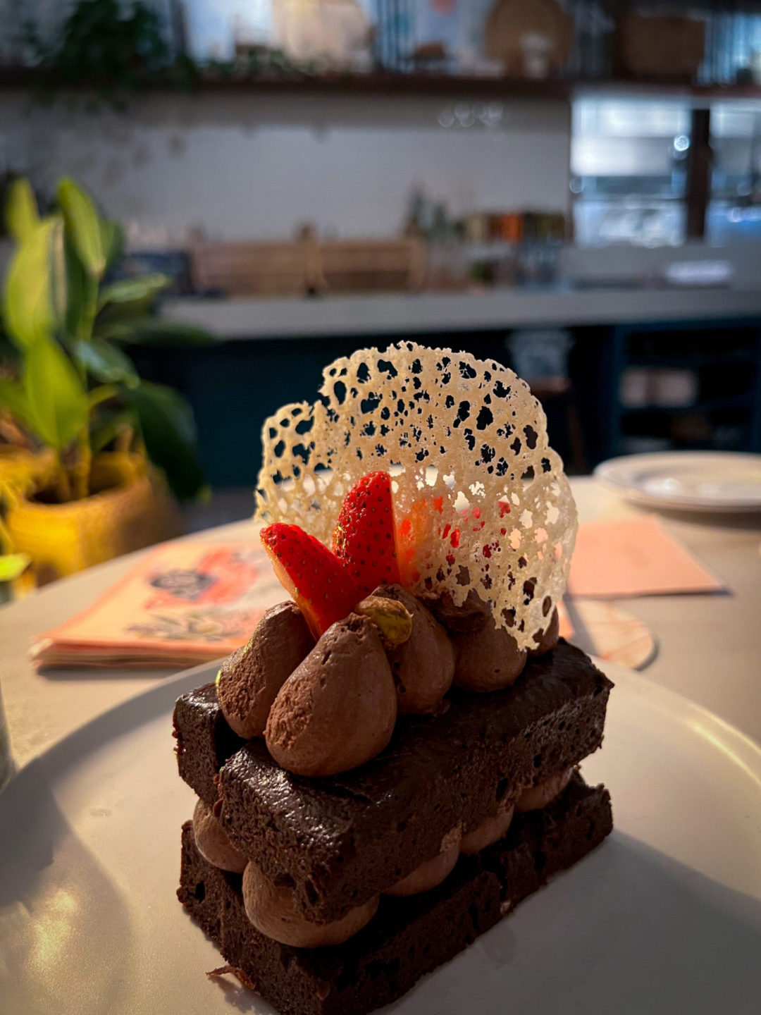 A vegan chocolate cake topped with chocolate frosting and strawberries from Ms. Piper's on Grand Cayman Island