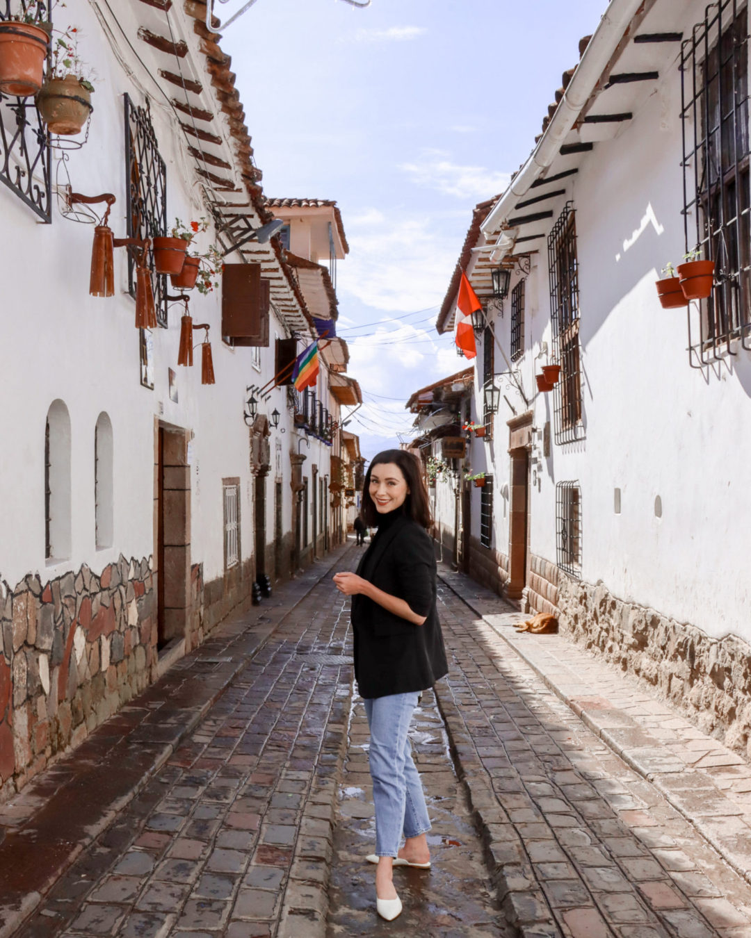 Travel Blogger Jordan Gassner smiling at camera on Calle Carmen Alto in Cusco, Peru