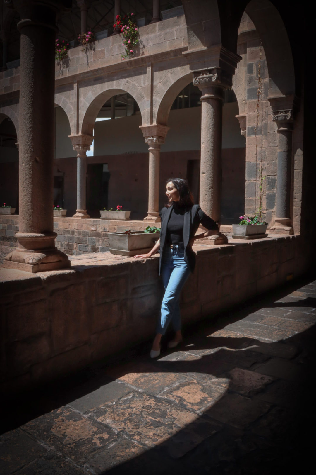 Travel Blogger Jordan Gassner standing on one of the edges of the courtyard at Qoricancha Temple in Cusco, Peru