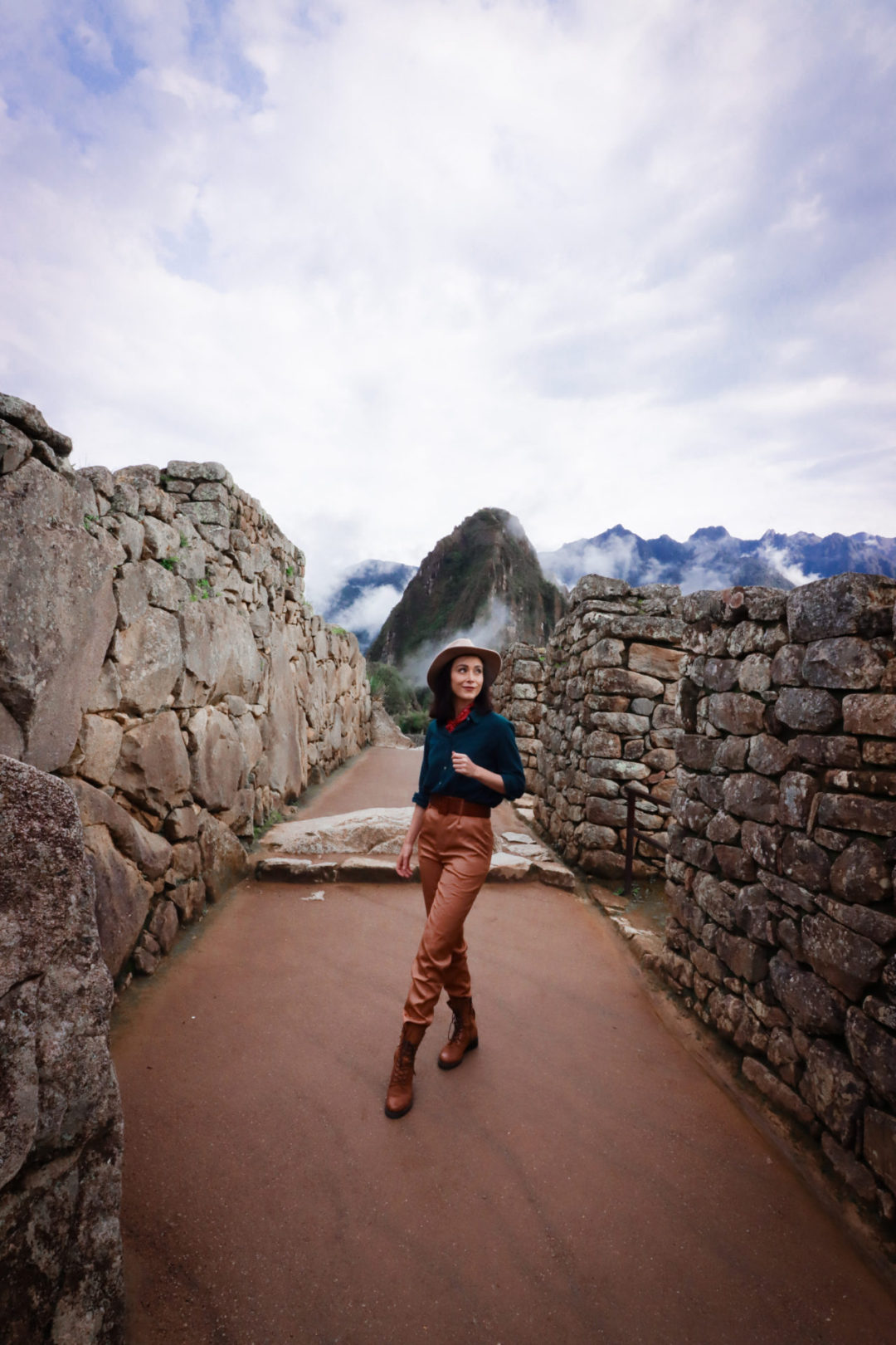 Travel Blogger Jordan Gassner standing in the center of an empty walkway in Machu Picchu City