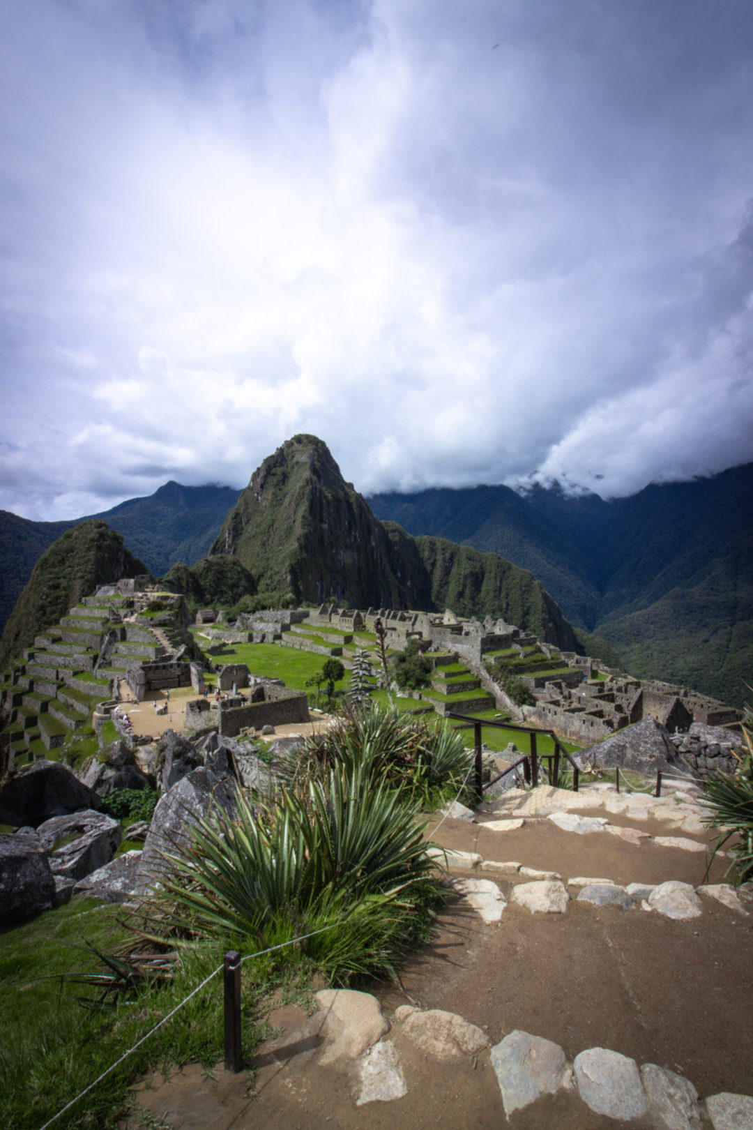 Machu Picchu By Train: A view down a set of stairs into Machu Picchu towards Huayna Picchu in Peru
