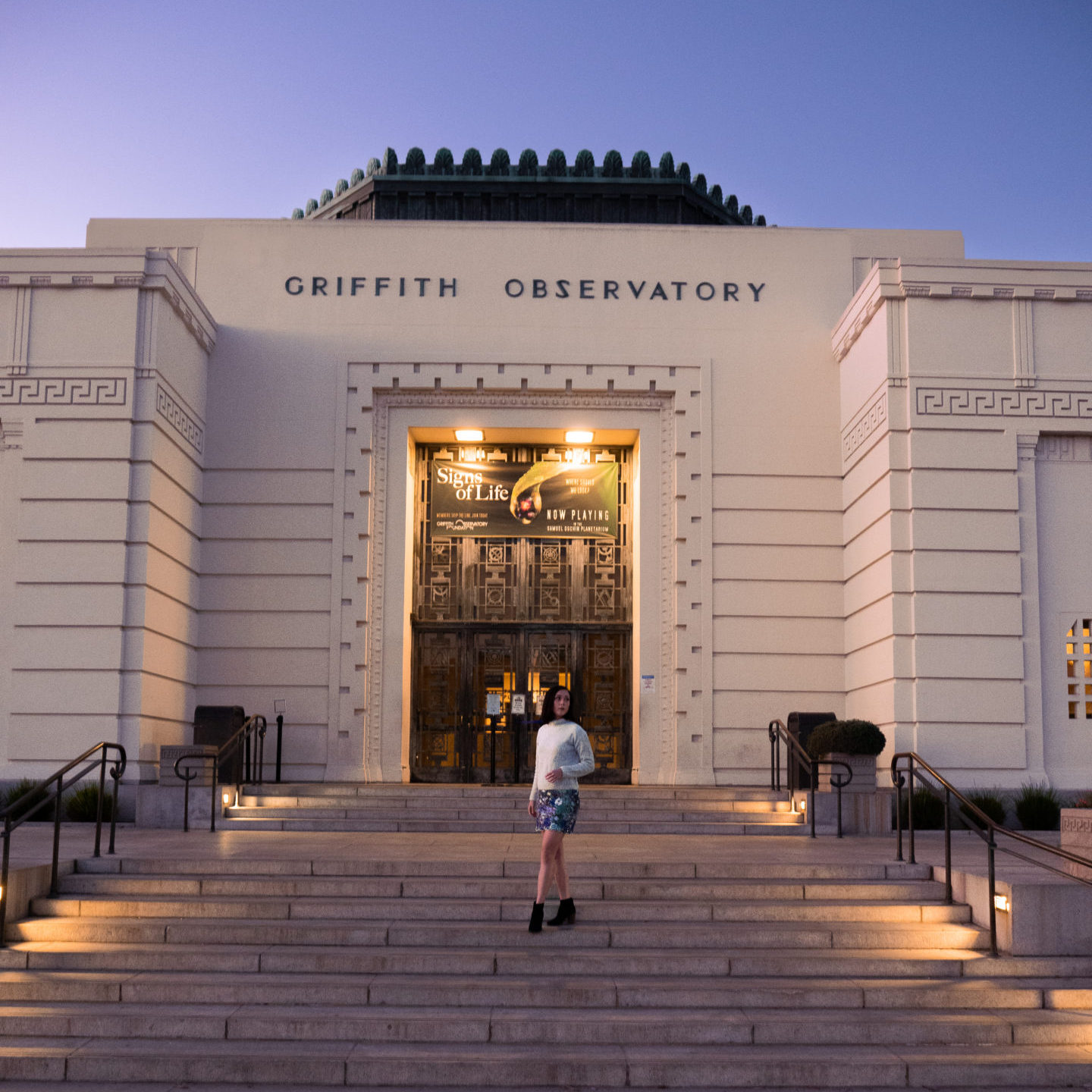 Travel Blogger Jordan Gassner standing on the front steps of the Griffith Observatory just before sunrise