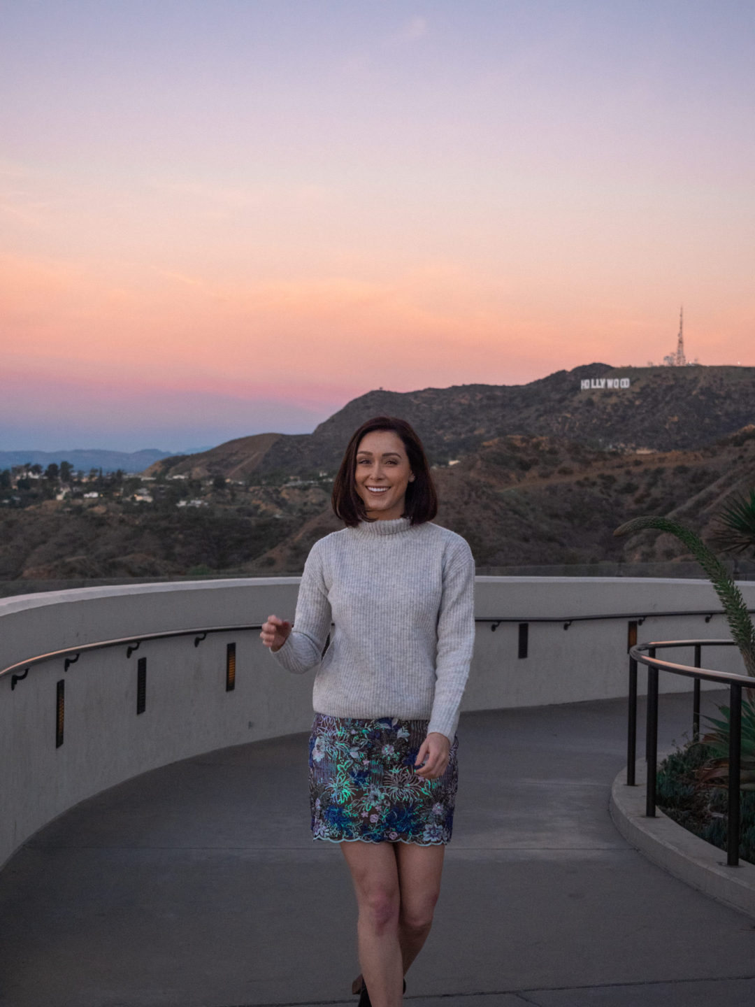 Travel Blogger Jordan Gassner walking up the western outdoor ramp alongside Griffith Observatory to get Hollywood Sign photos