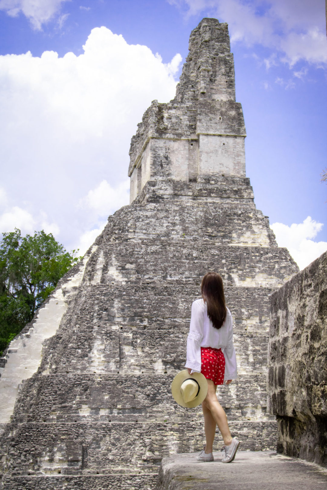Travel Blogger Jordan Gassner looking out at the profile view of Templo IV in Tikal National Park