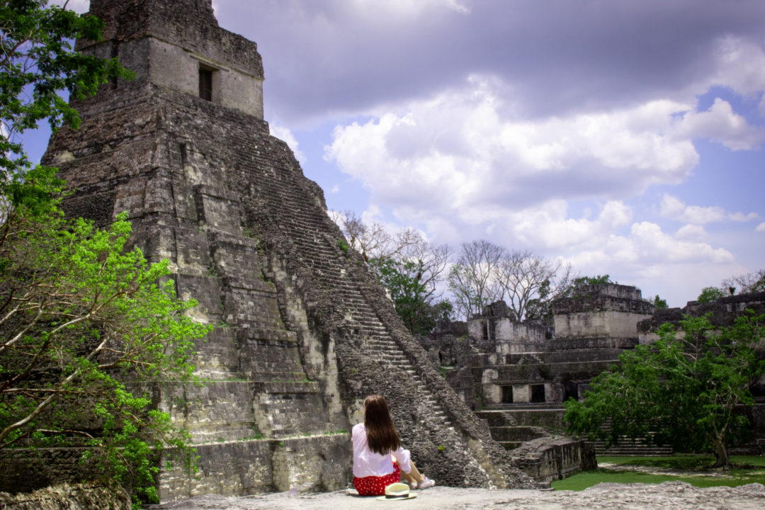 Travel Blogger Jordan Gassner sitting on a view point near Templo IV in Tikal National Park