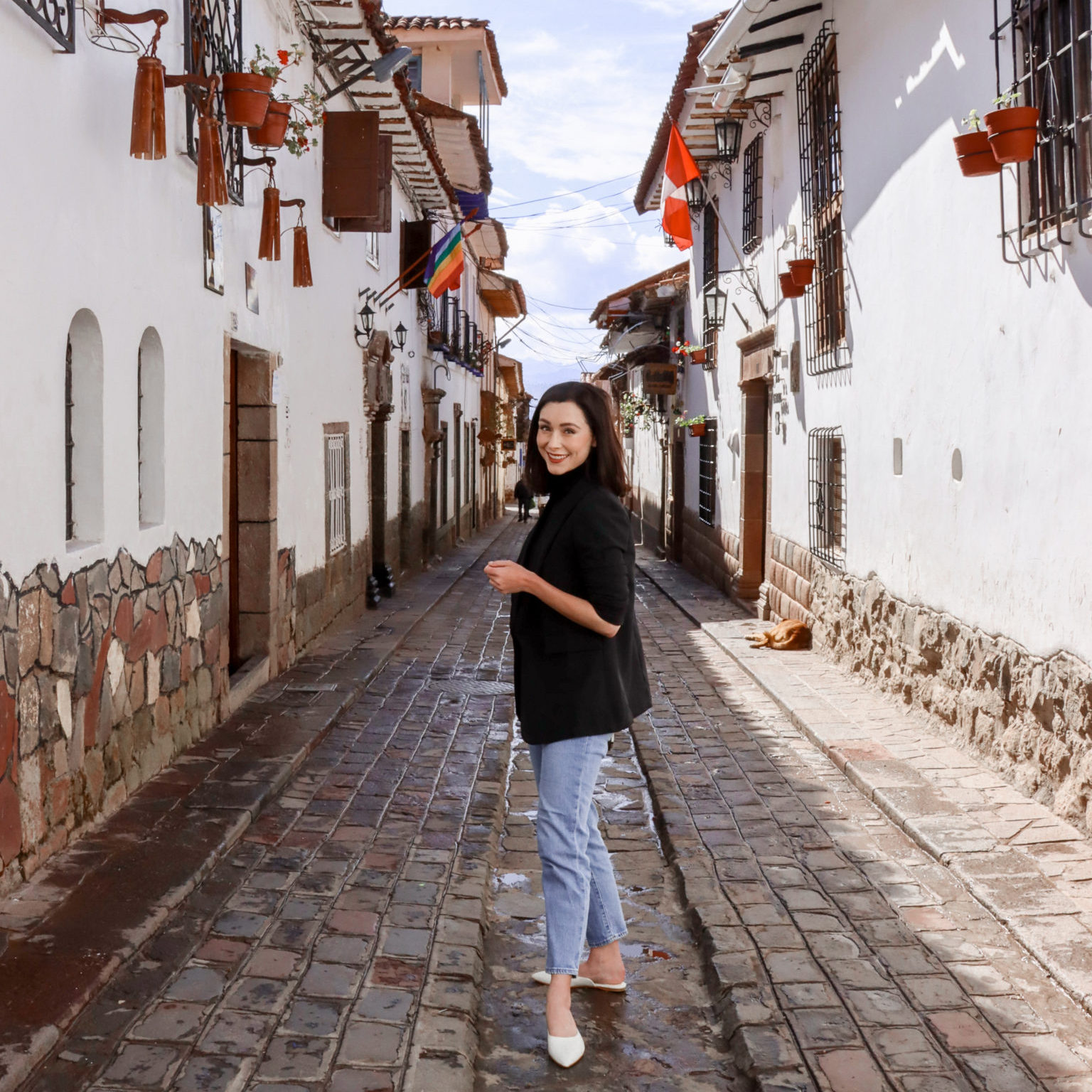 Travel Blogger Jordan Gassner smiling at camera on Calle Carmen Alto in Cusco, Peru