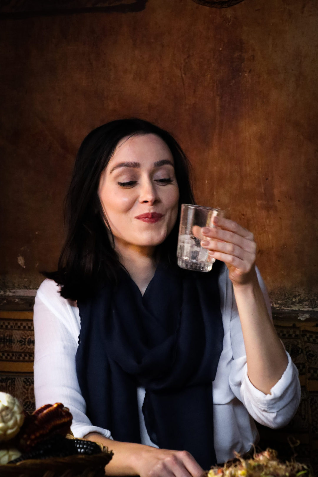 Travel Blogger Jordan Gassner holding at an empty glass of chicha and smiling in Peru's Sacred Valley