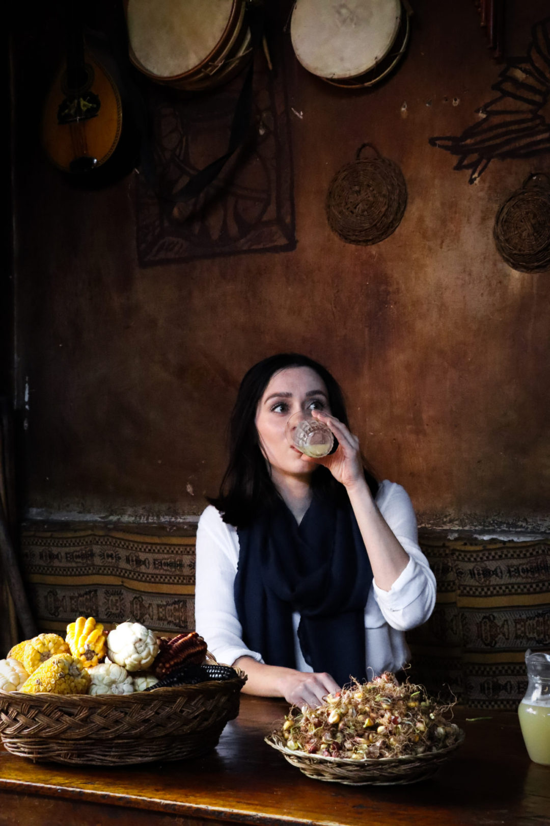 Travel Blogger Jordan Gassner drinking a glass of chicha at a local bar in Peru's Sacred Valley