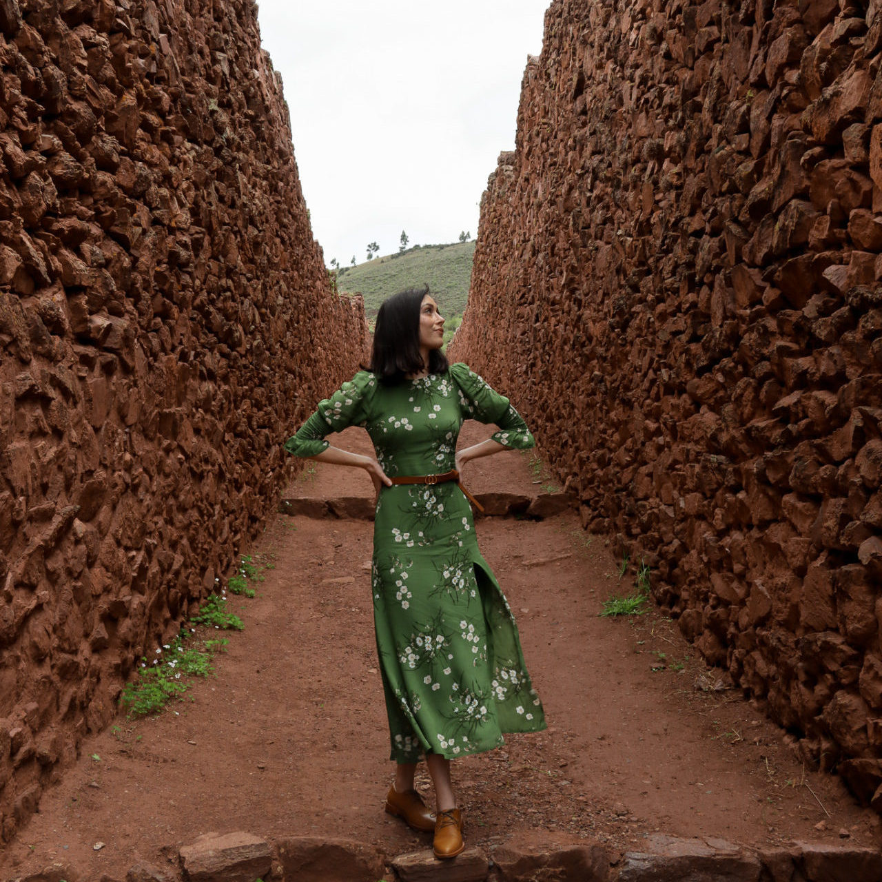 Jordan Gassner staring up at a high wall along an ancient road at the pre-Incan site, Pikillacta, near Cusco, Peru.