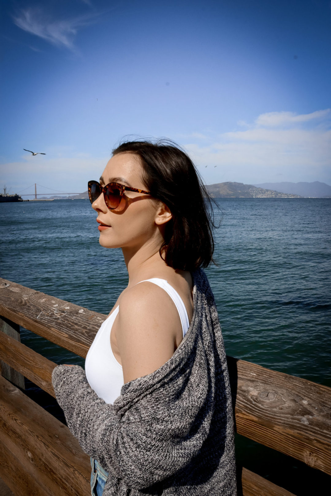 Travel Blogger Jordan Gassner standing in front of they Golden Gate Bridge lookout point at Pier 39 in San Francisco