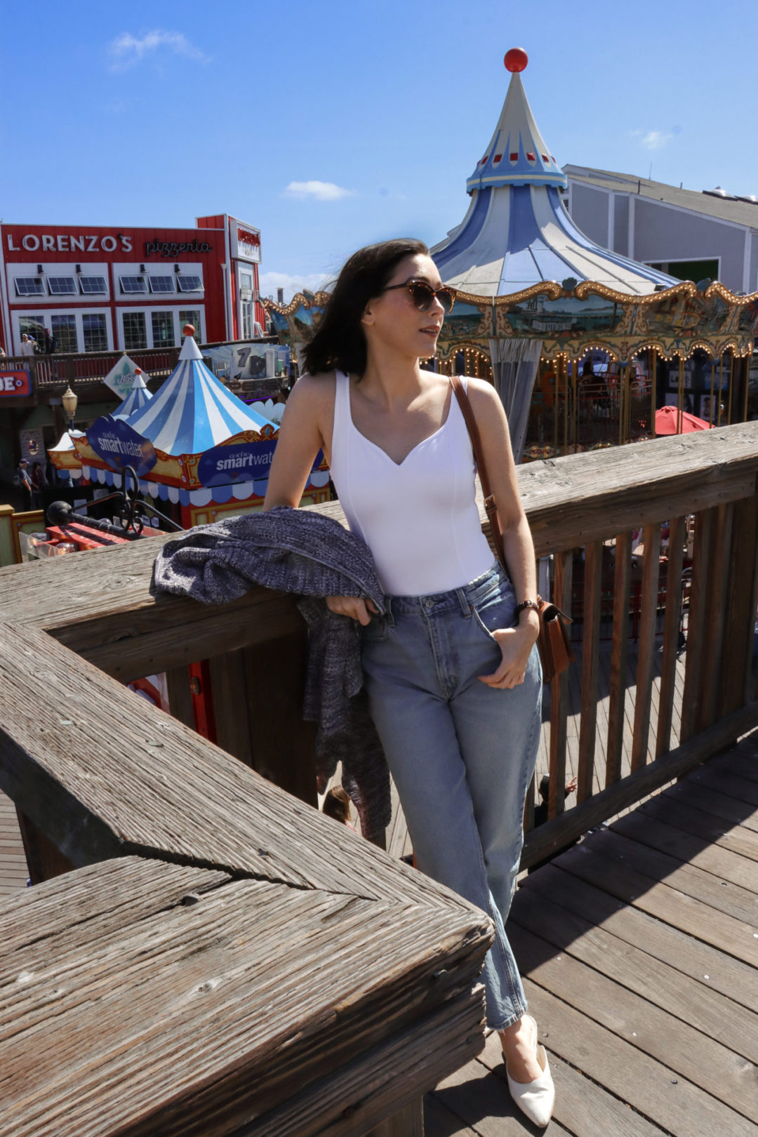 Travel Blogger Jordan Gassner standing on the second floor platform overlooking the Carousel in San Francisco's Pier 39