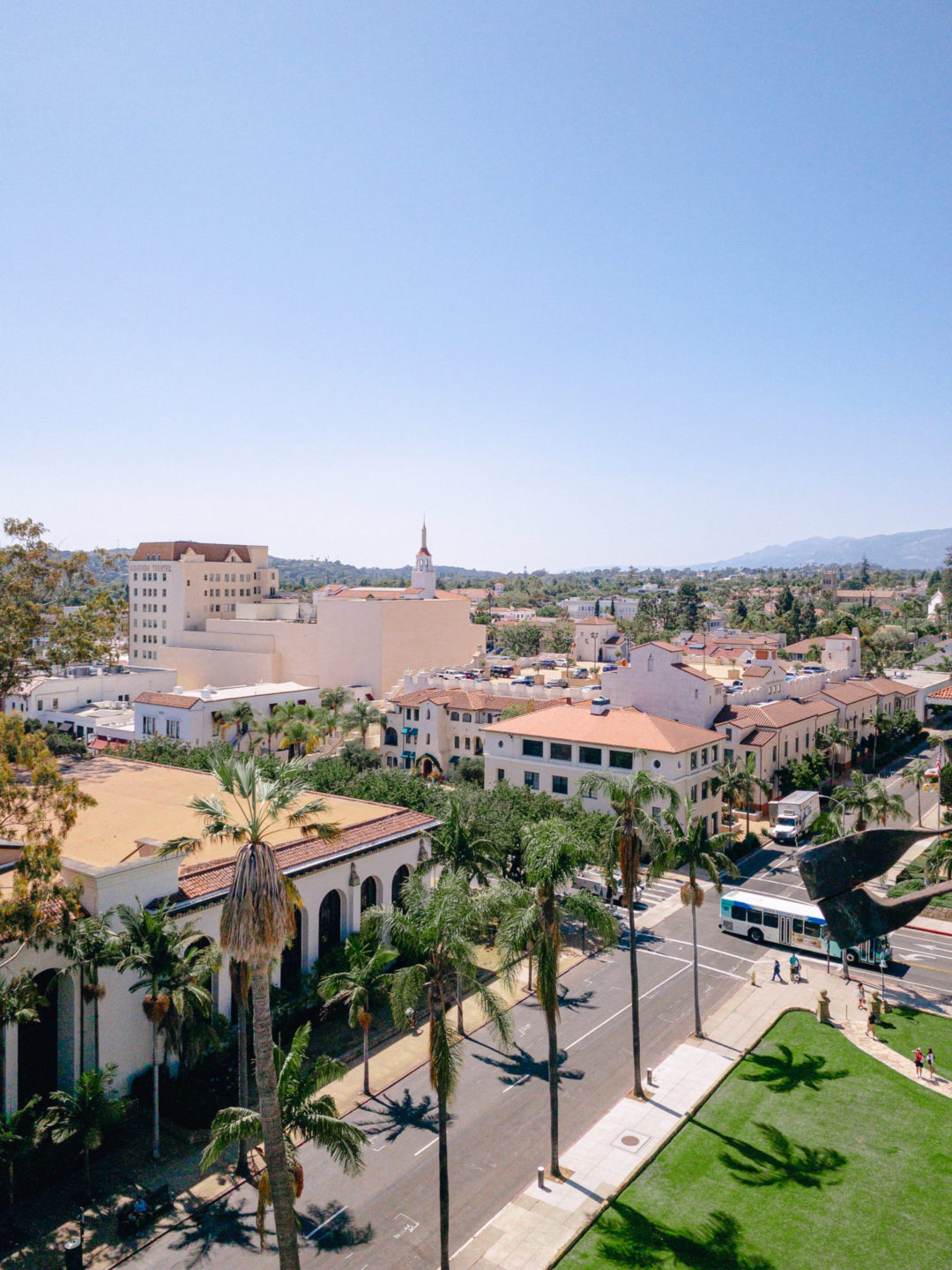 An aerial view of Santa Barbara's red tiled roofs and palm tree lined streets