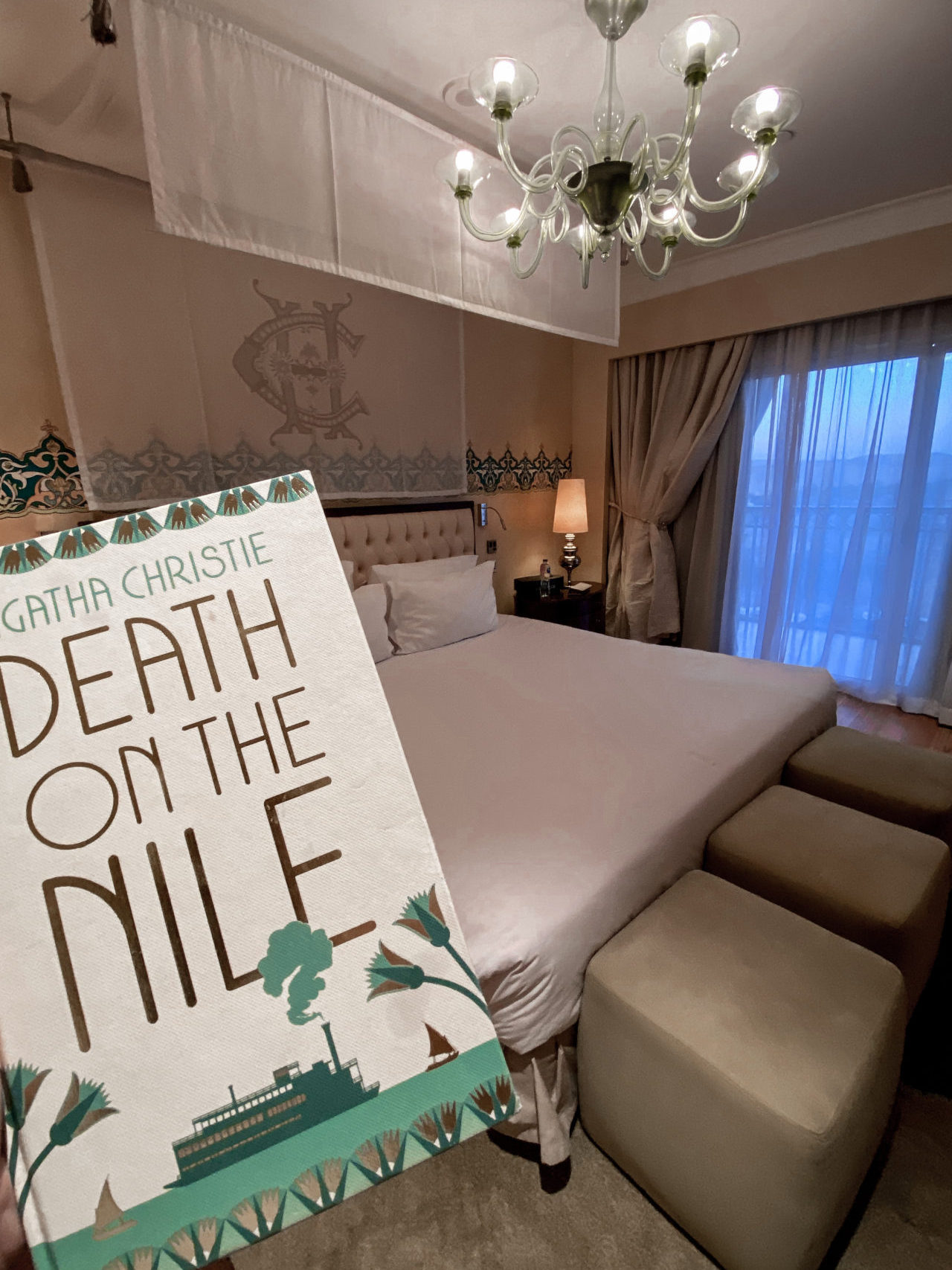 A hardcover of "Death on the Nile" by Agatha Christie inside a luxury room in the Sofitel Legend Old Cataract Hotel in Aswan, Egypt