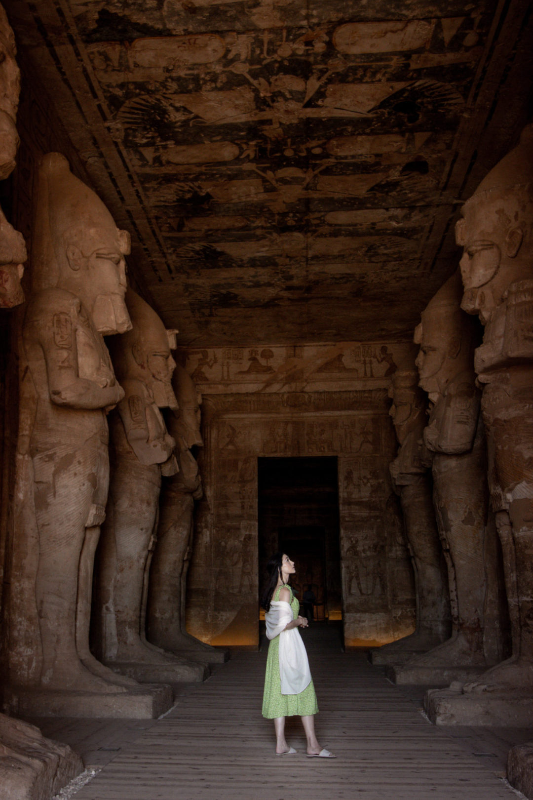 Travel Blogger Jordan Gassner staring up at one of statues inside the Great Temple at Abu Simbel in Egypt 