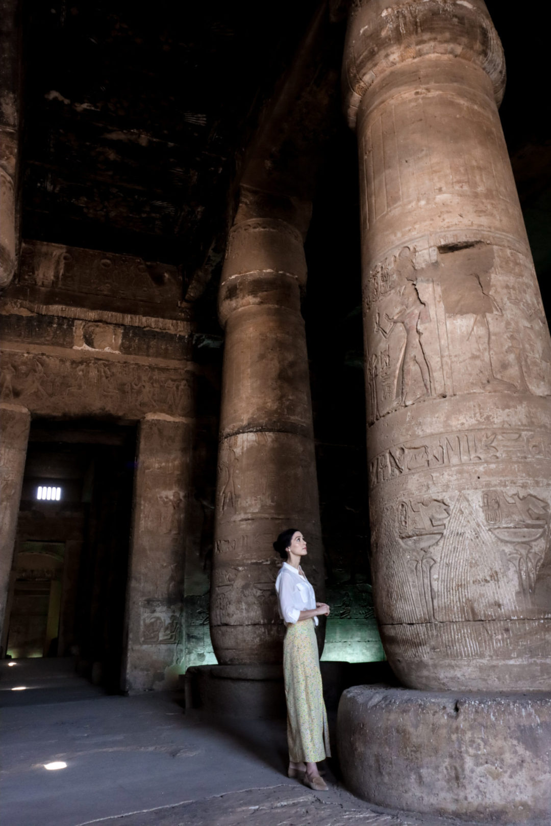 Travel Blogger Jordan Gassner looking up at a column in Abydos Temple's Hypostyle Hall