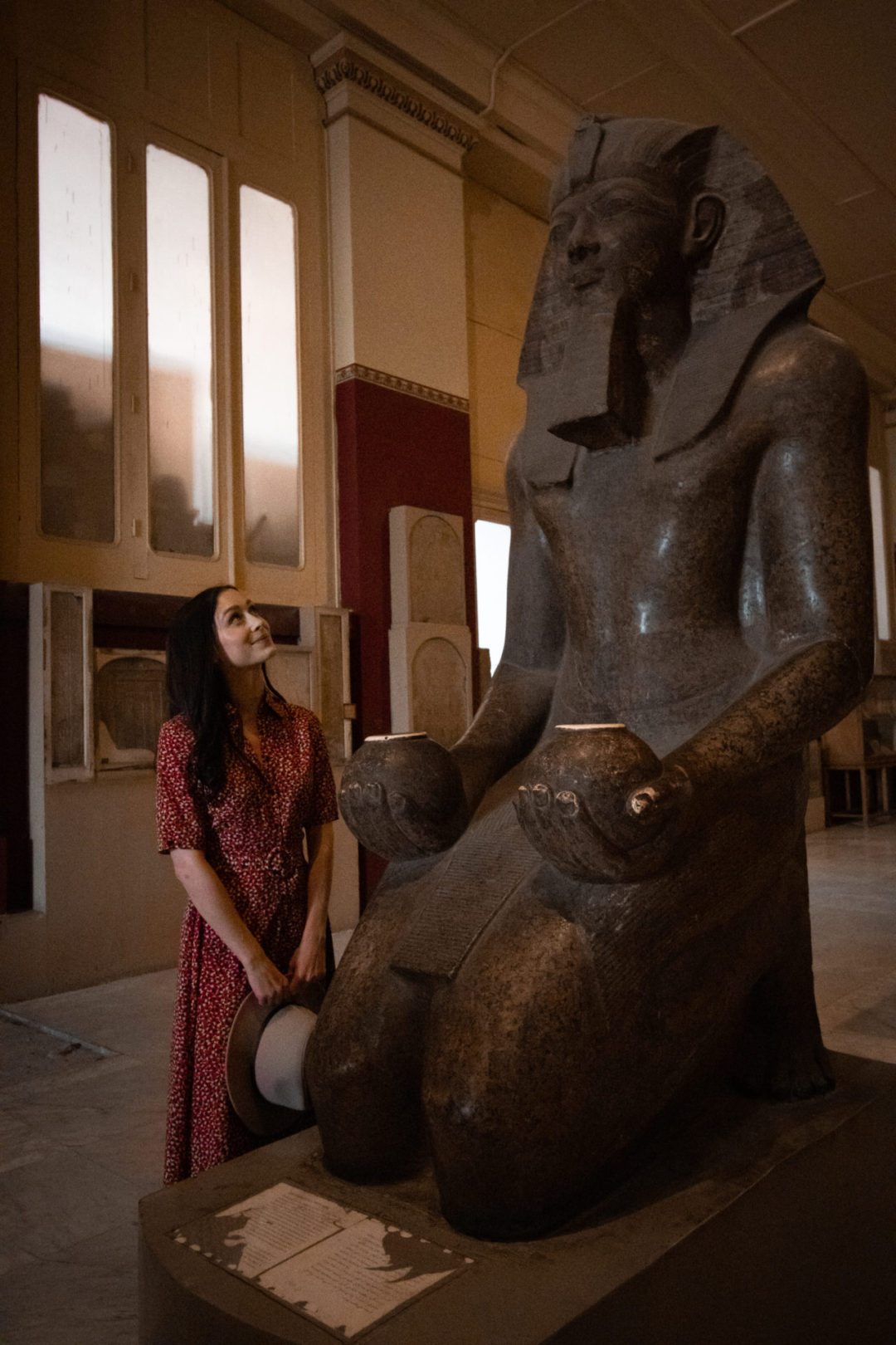 Travel Blogger Jordan Gassner staring up at a statue of Pharaoh Hatshepsut inside the Museum of Antiquities in Cairo