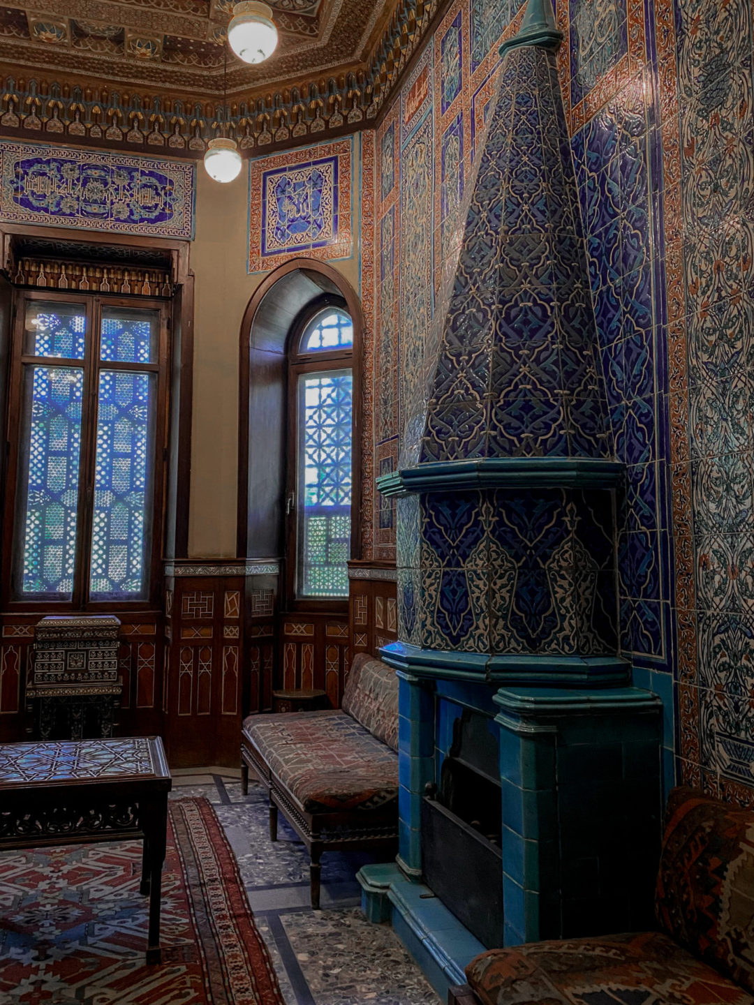 A bright blue tile fireplace inside the Manial Palace Museum in Egypt