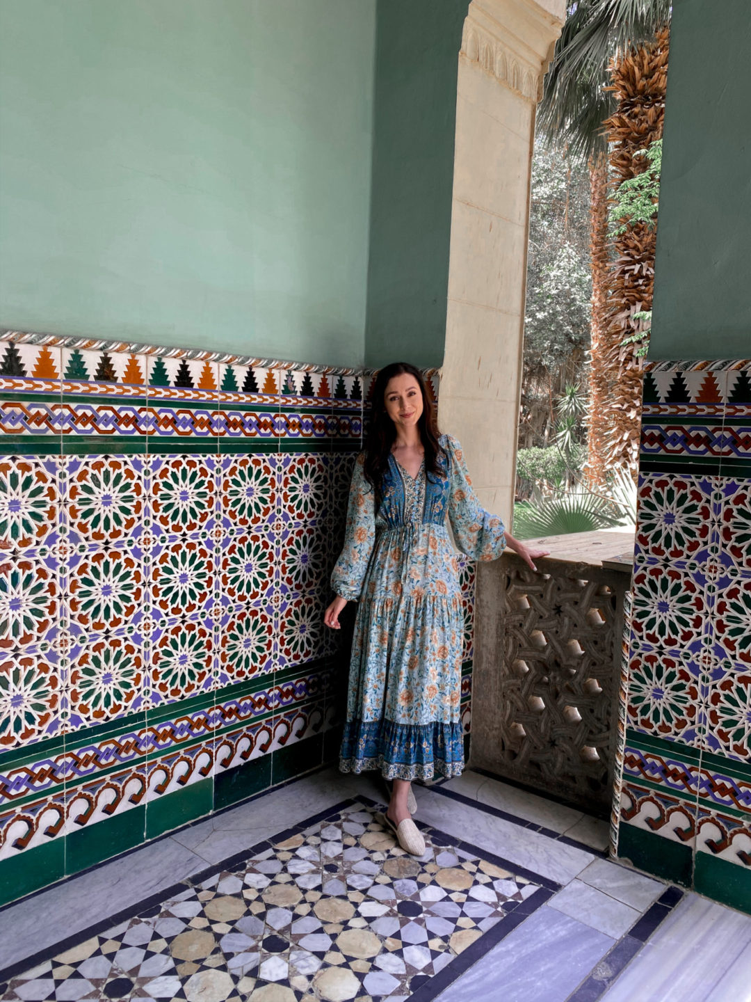 Travel Blogger Jordan Gassner standing under a porch overlooking the Manial Palace Museum Gardens in Egypt