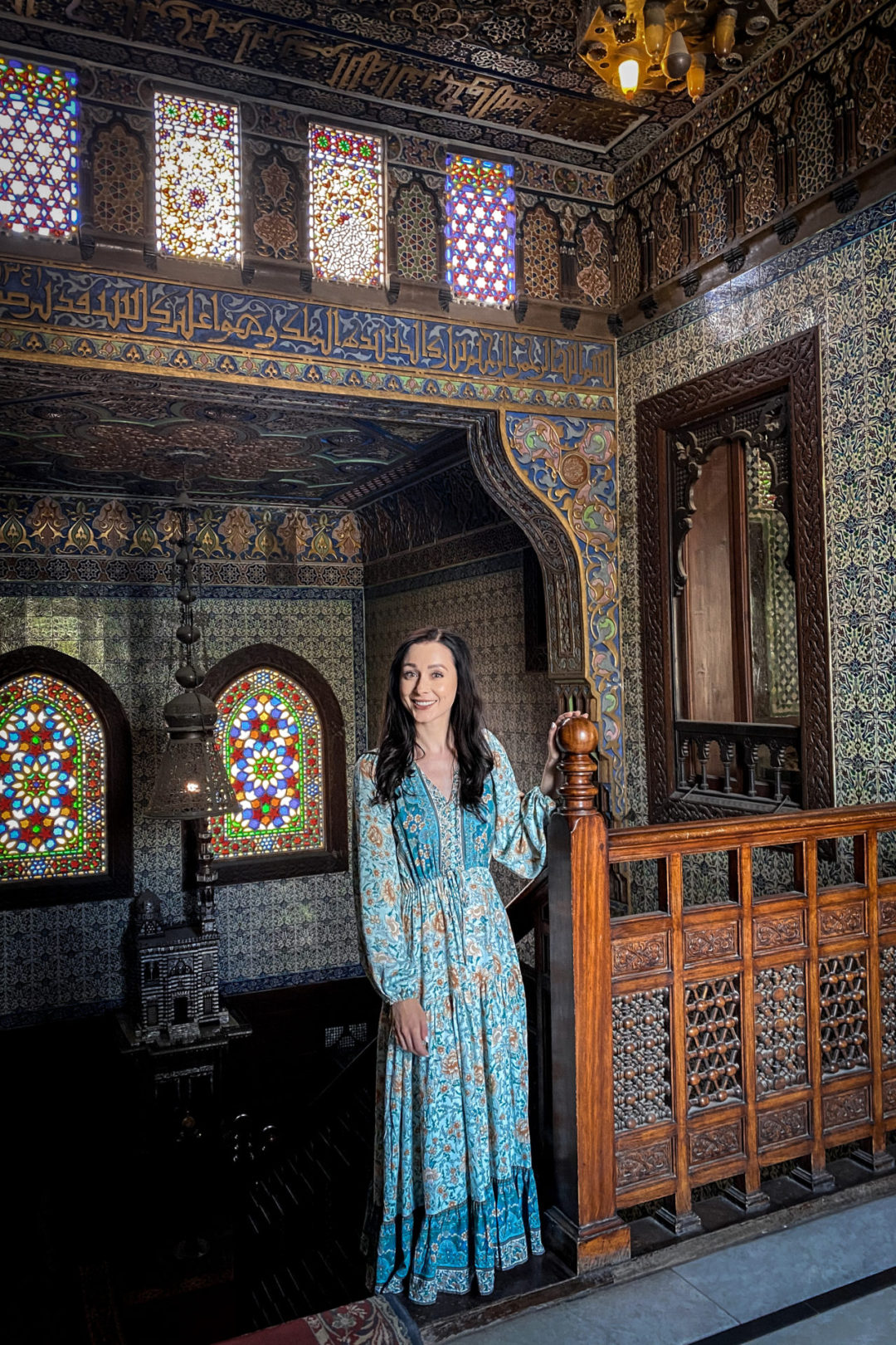 Travel Blogger Jordan Gassner standing and smiling at the top of a stairwell in Manial Palace Museum in Cairo, Egypt