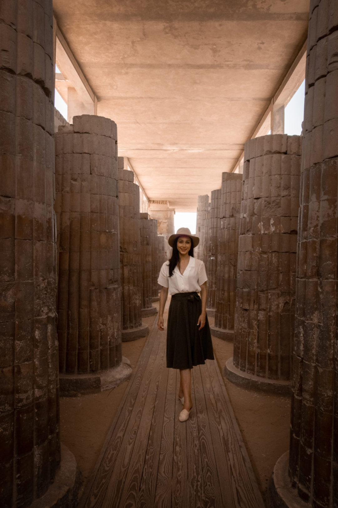 Travel Blogger Jordan Gassner standing inside a colonnade on the Saqqara Necropolis in Egypt
