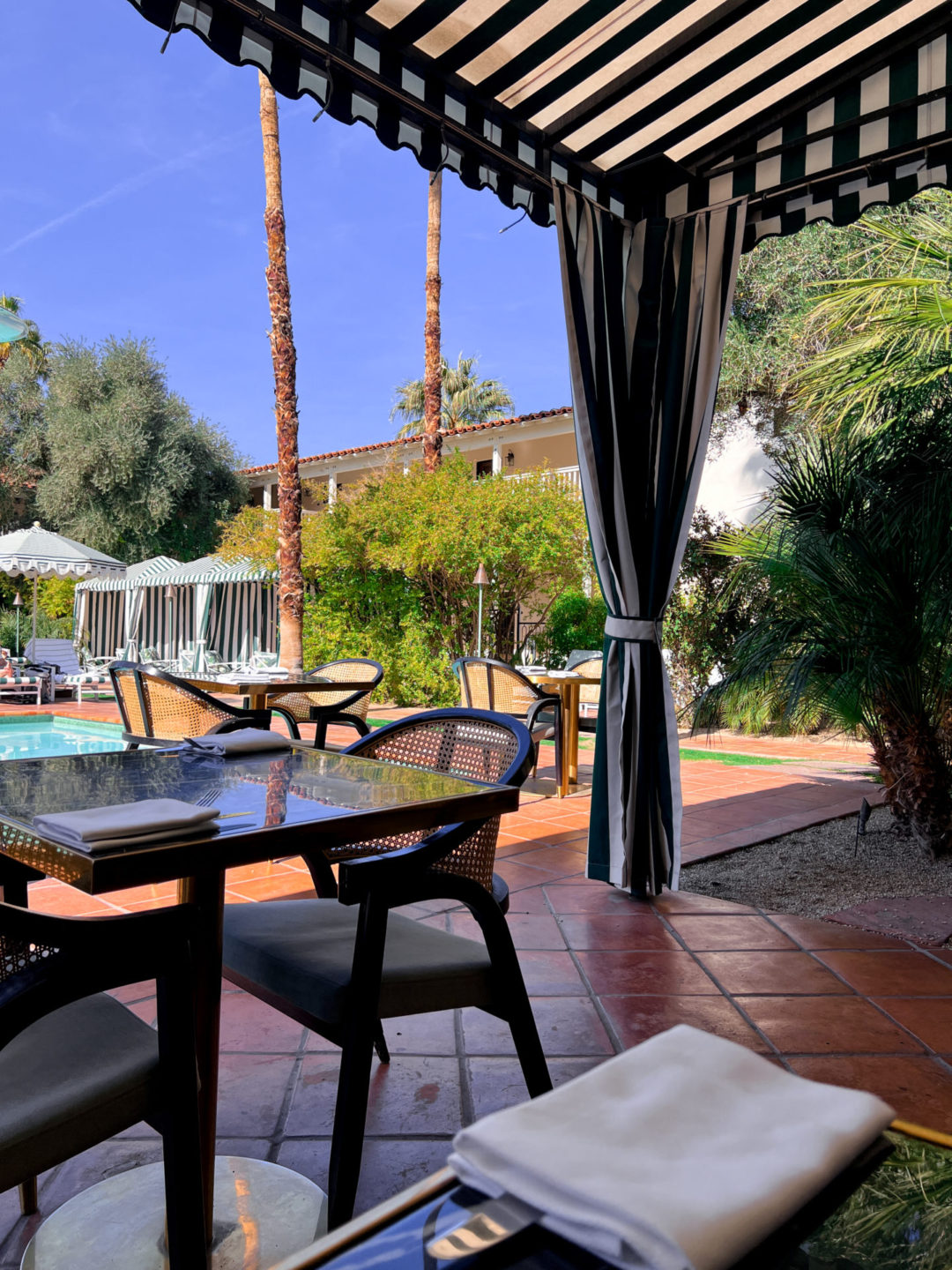 Don't Worry Darling Travel Aesthetic: The outdoor tables at the Colony Club Restaurant in Palm Springs, California, USA