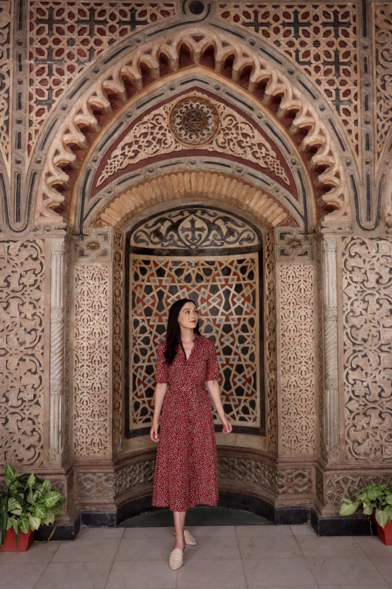 Travel Blogger Jordan Gassner standing in front of an intricate archway at Coptic Cairo's Hanging Church