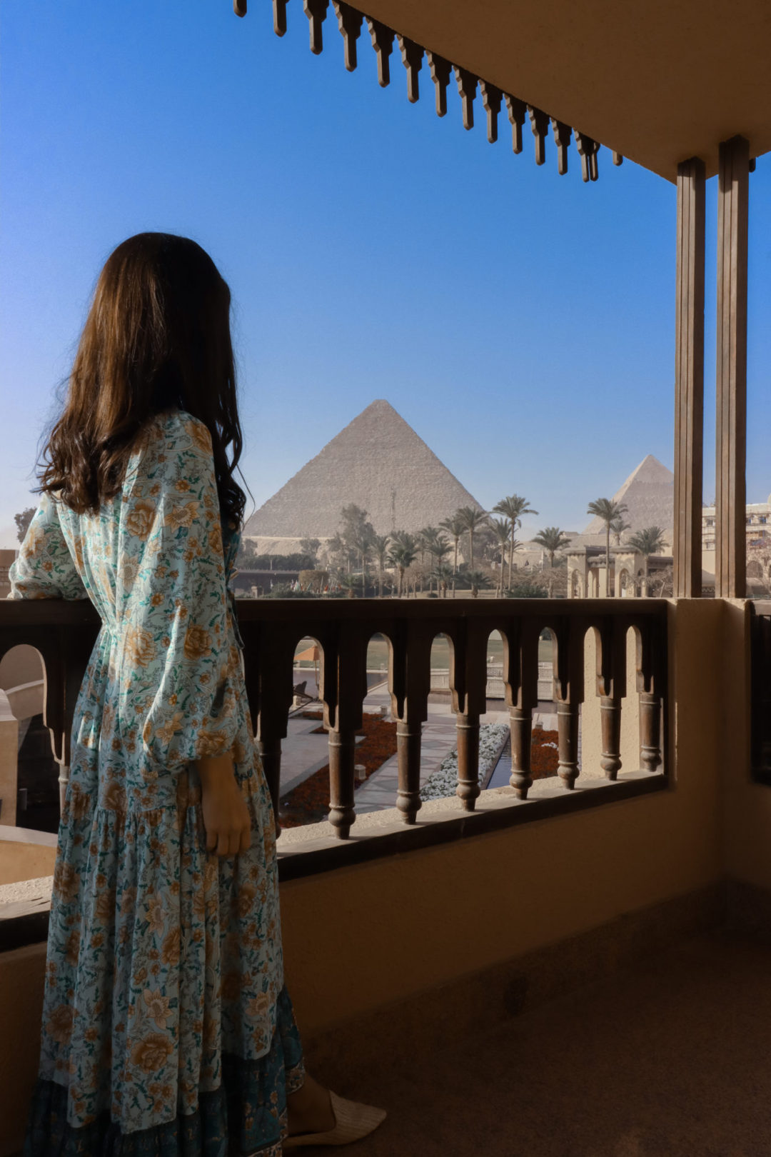 Travel Blogger Jordan Gassner looking at the Pyramids of Giza from a stairway viewpoint at Marriott Mena House in Egypt