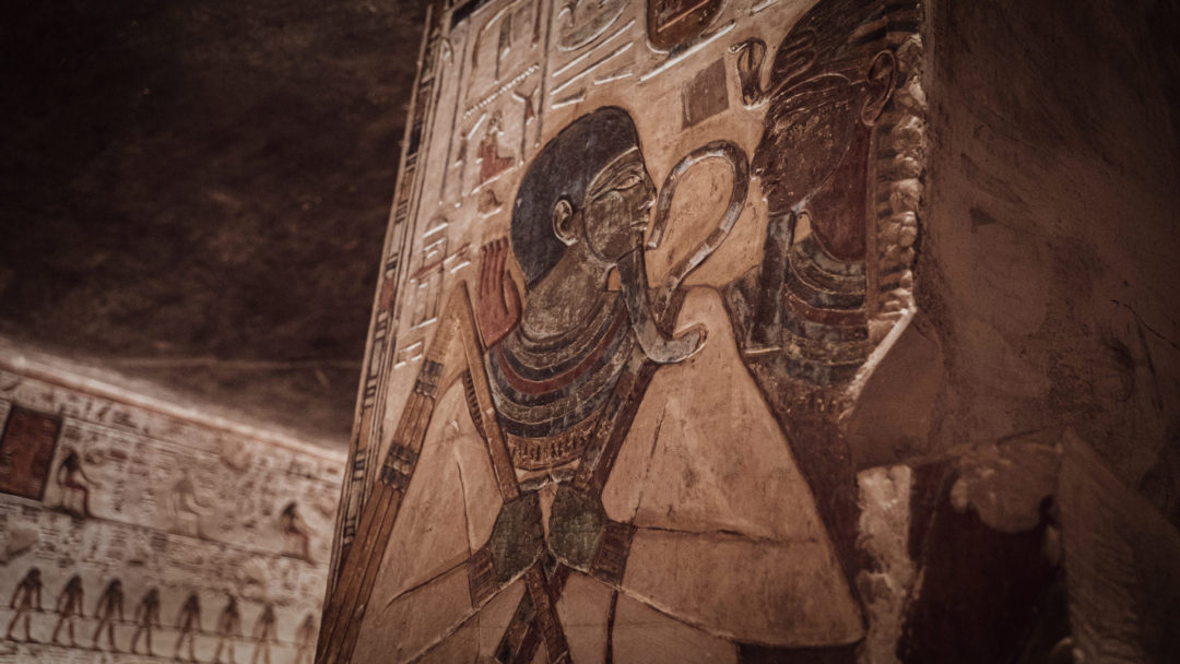 Colorful hieroglyphs depicting Osiris, god of the dead, in Luxor, Egypt