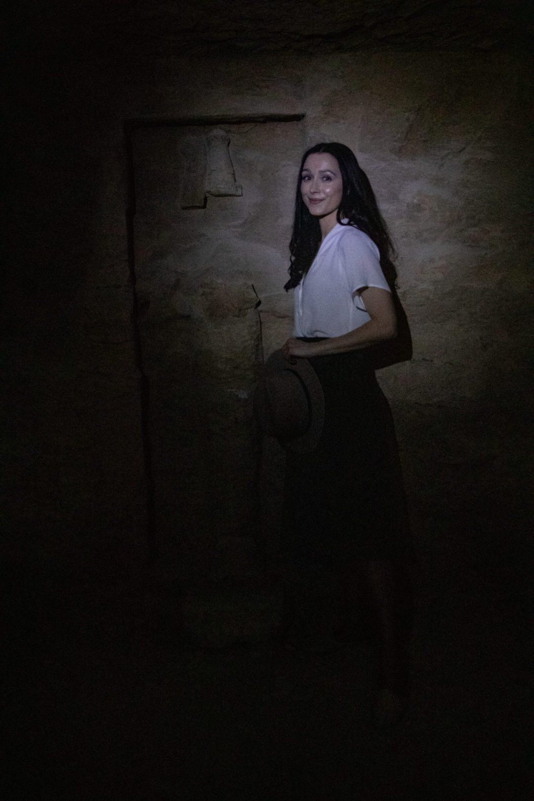 Travel Blogger Jordan Gassner standing inside a dark passage in the ancient Tomb of Merenptah in the Valley of the Kings