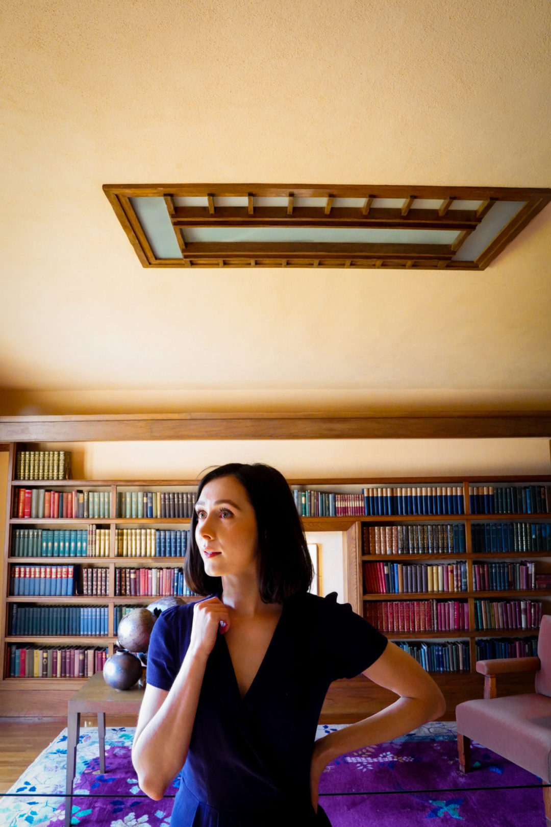 Travel Blogger Jordan Gassner standing inside the library doorway at Hollyhock House, a UNESCO World Heritage Site