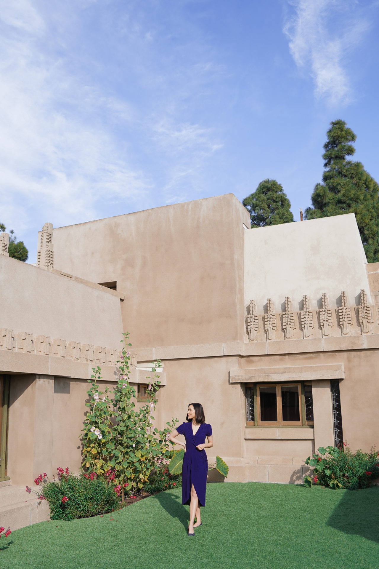 Travel Blogger Jordan Gassner standing in the backyard of the famous Hollyhock House, commissioned by American oil heiress, philanthropist and art patron, Aline Barnsdall