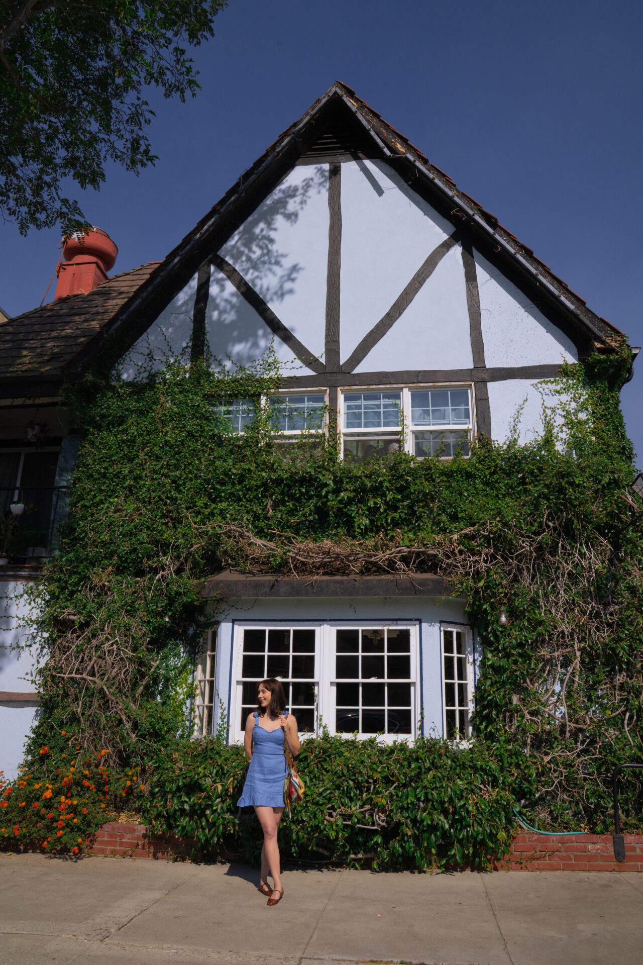 Travel Blogger Jordan Gassner standing in front of a traditional Danish designed building in Solvang, California