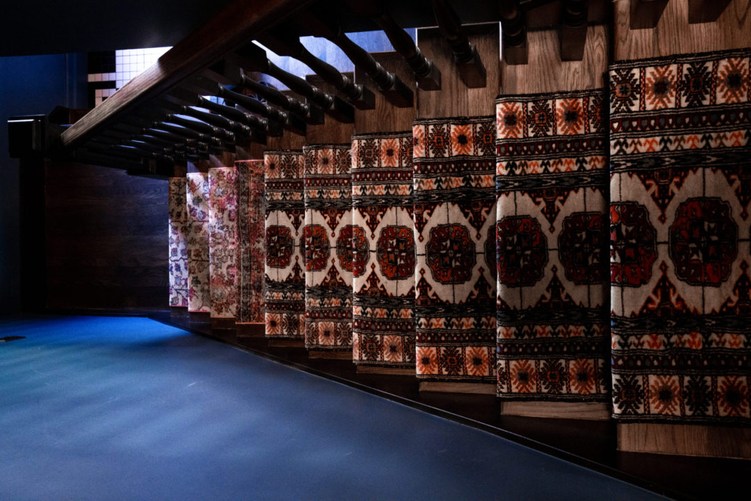 Four portraits of women with big hair above the kitchen sink in Lucille's Manor at the Noble and Proper Hotel in Big Bear, California