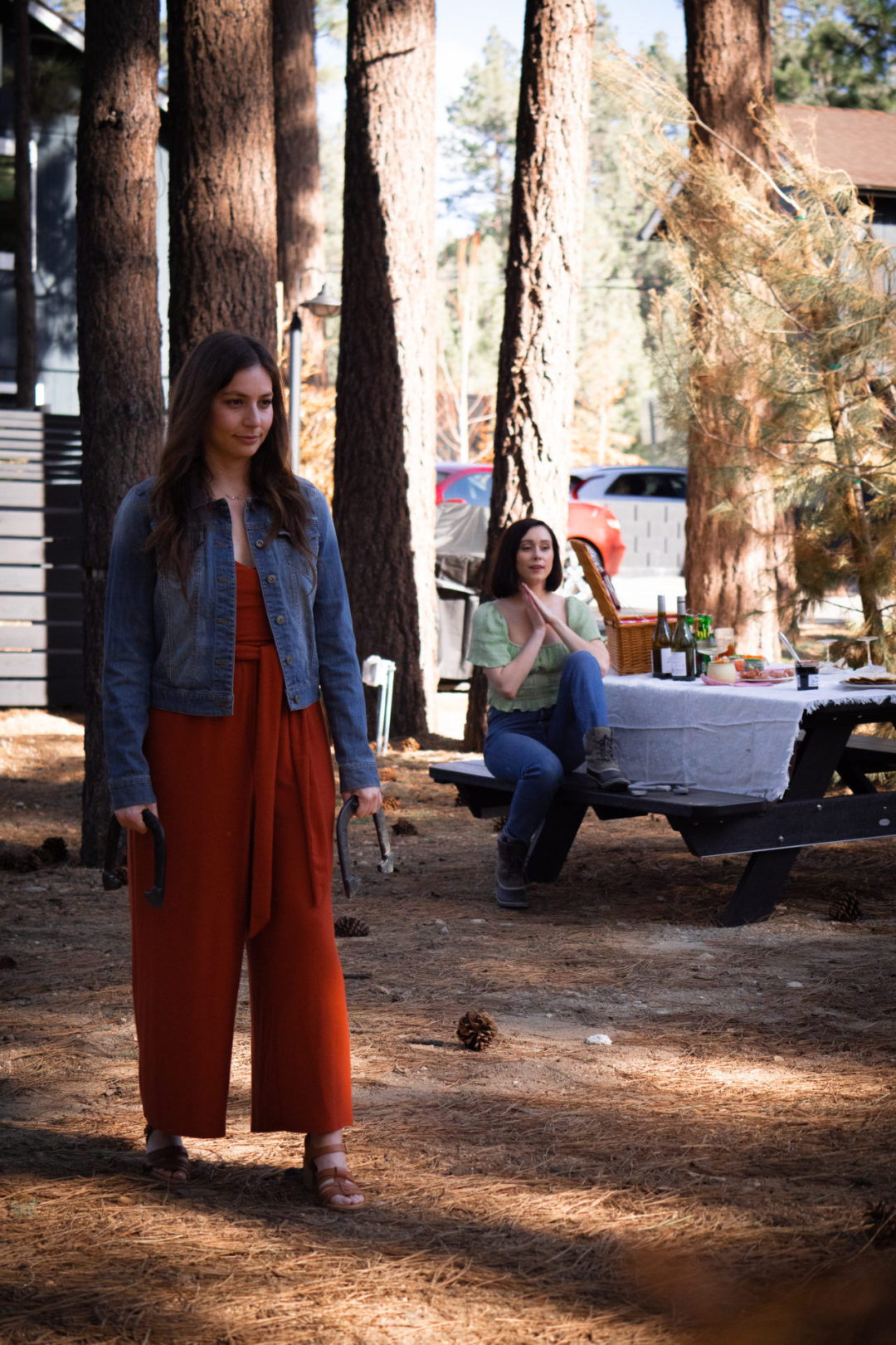 Travel Blogger Jordan Gassner cheering on her friend Sarah playing horseshoes at the Noble + Proper Hotel in Big Bear, California