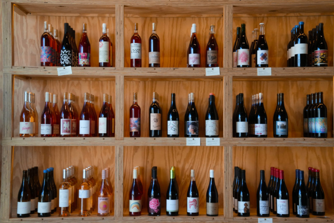 A wooden display shelf full of rose and red wines inside the mother-daughter owned DIA Natural Wine Store in Studio City, California