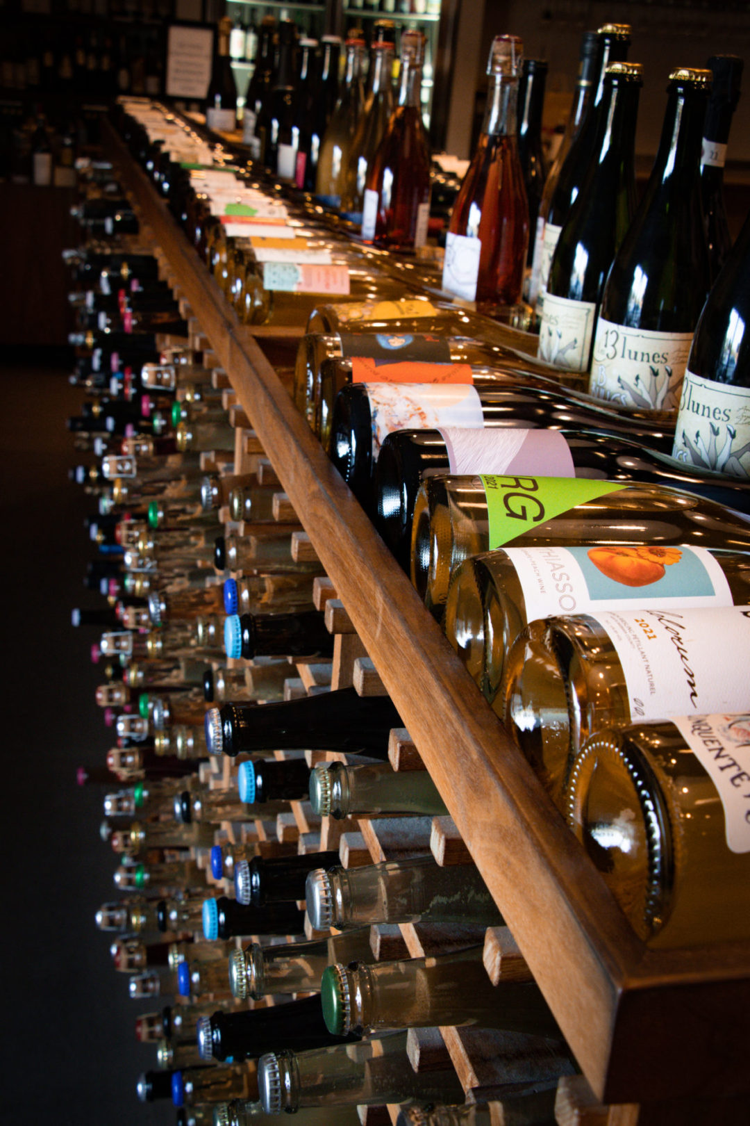 Natural Wine Stores in Los Angeles: A row of natural wine bottles inside Domaine LA in Hollywood, California