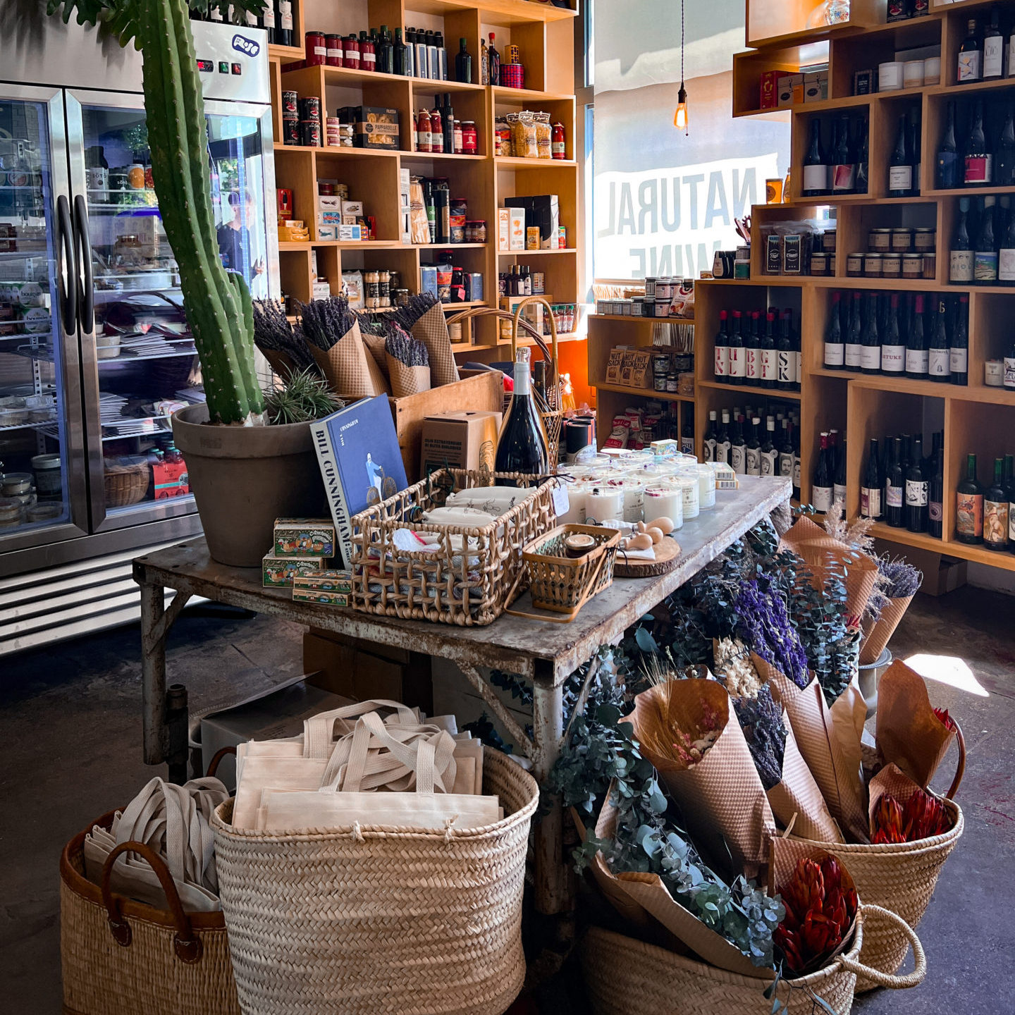 Natural Wine Stores in Los Angeles: A display table with cookbooks, candles and fresh lavender inside Vin On Rose in Venice, California