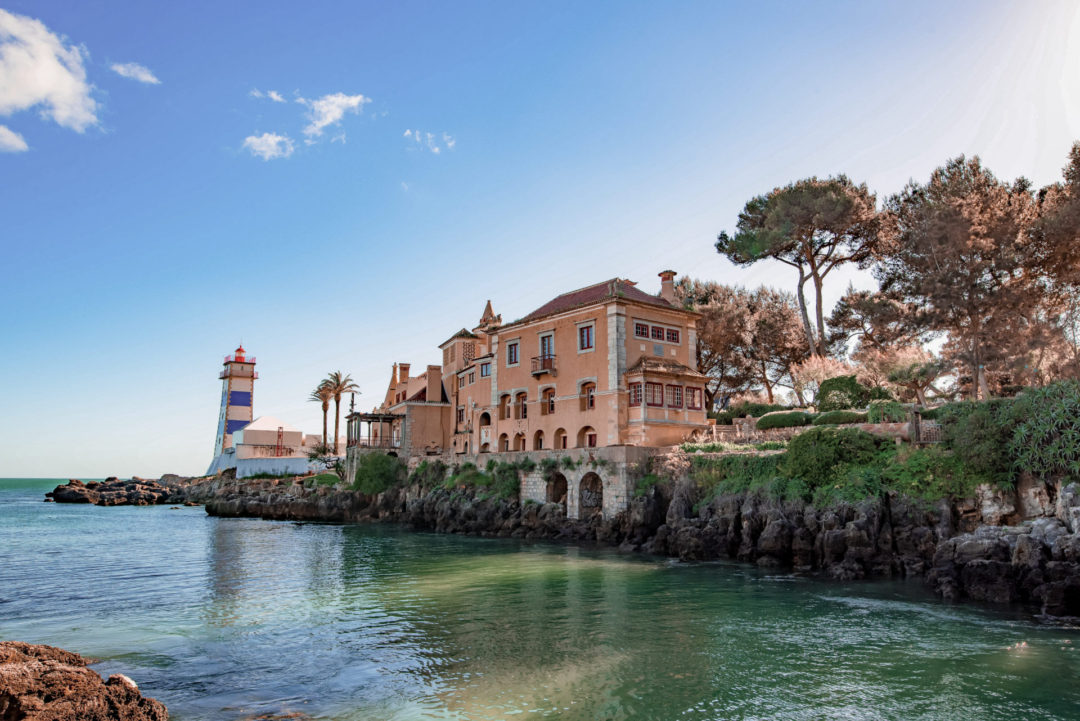 A villa and lighthouse near the water in Cascais, Portugal
