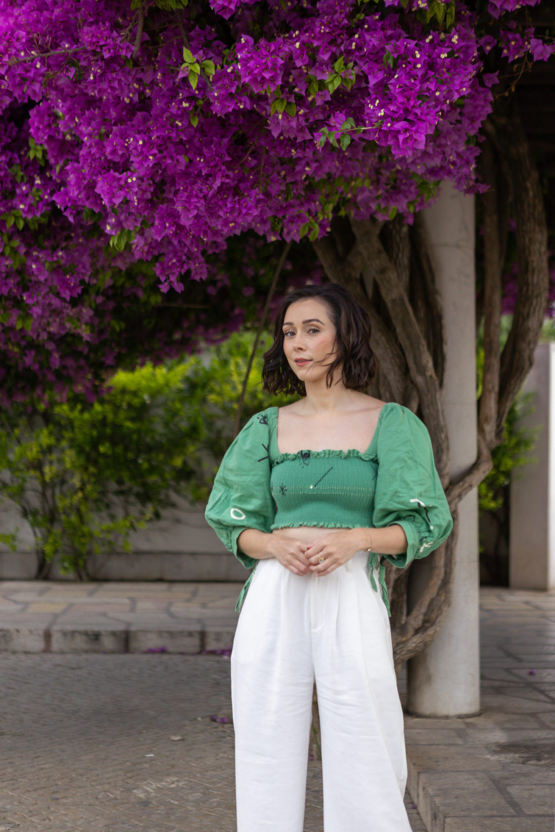 Travel Blogger Jordan Gassner wearing Capulet, Nonchalant the Label and vintage rings in front of a Bougainvillea tree in Lisbon, Portugal