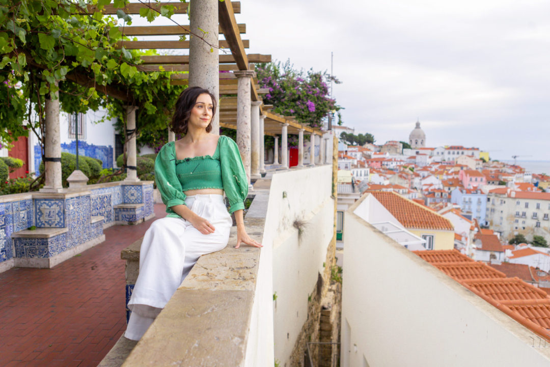 Travel Blogger Jordan Gassner looking out at Lisbon from Miradouro de Santa Luzia.