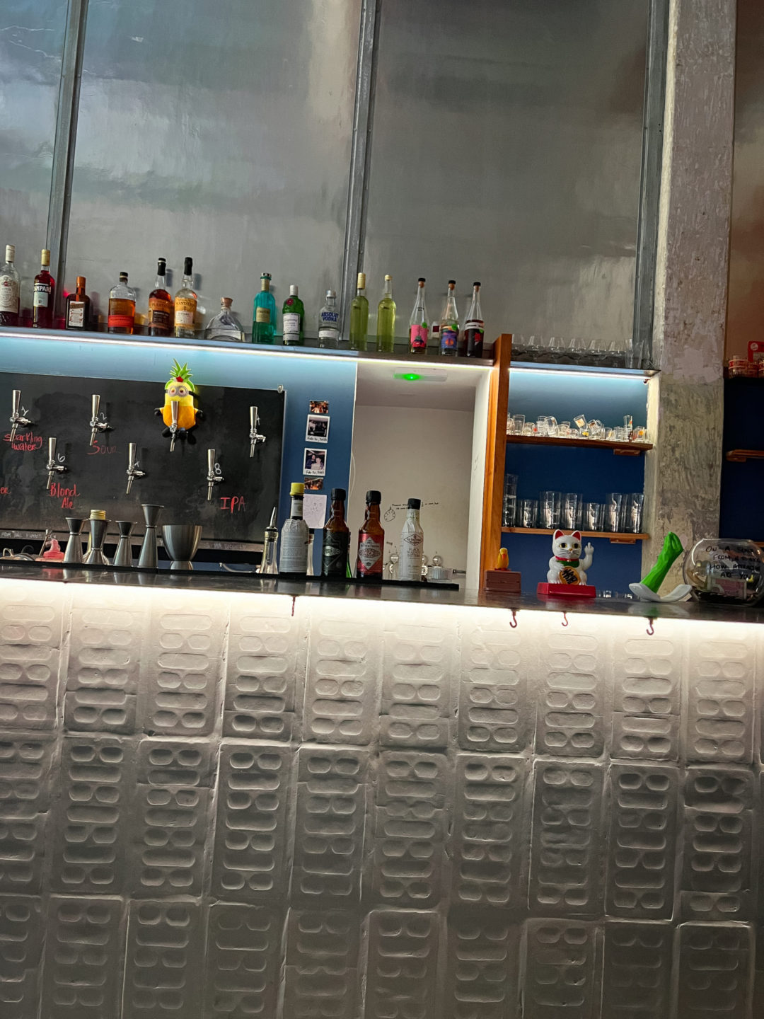 A full bar with hard alcohol, wine and beer on-tap at Tricky's in Lisbon, Portugal, one of the best places to drink natural wine in lisbon